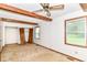 Bedroom showcasing beamed ceilings, carpet, and a window that provides bright natural light at 9608 Sycamore Rd, Carmel, IN 46032