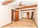 Bedroom featuring a ceiling fan, exposed wood beams, and a double-door closet for ample storage space at 9608 Sycamore Rd, Carmel, IN 46032