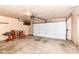 Spacious garage featuring a white garage door, overhead lighting, and ample room for vehicles or storage at 9608 Sycamore Rd, Carmel, IN 46032