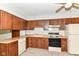 Functional kitchen featuring warm wood cabinets, laminate countertops, and room for customization at 9608 Sycamore Rd, Carmel, IN 46032
