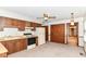 Classic kitchen layout with warm cabinets and appliances offers practicality and room for updates at 9608 Sycamore Rd, Carmel, IN 46032