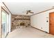 Cozy living room with stone fireplace and sliding glass doors leading to the outdoors at 9608 Sycamore Rd, Carmel, IN 46032