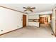 Open-concept living room and kitchen area with ceiling fan and natural light at 9608 Sycamore Rd, Carmel, IN 46032