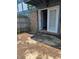 Back patio area with sliding glass door access to interior and enclosed wooden fence at 9794 Kingscross Ct, Indianapolis, IN 46235