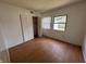 Small bedroom with laminate floor, closet, and natural light from two windows at 9794 Kingscross Ct, Indianapolis, IN 46235