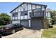 Two-story townhouse with a garage and dark trim detailing on a sunny day at 9794 Kingscross Ct, Indianapolis, IN 46235