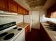 Galley-style kitchen with laminate countertops and an electric stovetop at 9794 Kingscross Ct, Indianapolis, IN 46235