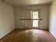 A bright living room shows wood floors, white walls, and sliding patio doors at 9794 Kingscross Ct, Indianapolis, IN 46235