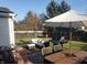 Inviting backyard patio with outdoor seating, grill, and mature trees, perfect for entertaining at 10197 Apple Blossom Cir, Fishers, IN 46038