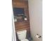 Cozy half-bath with rustic wood wall, decorative shelving and greenery, and traditional toilet at 10197 Apple Blossom Cir, Fishers, IN 46038