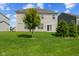 Lush backyard with vinyl siding on home and well-maintained trees at 1026 Sorrell Pass, Greenwood, IN 46143