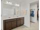 Bathroom featuring double sinks and a walk-in closet for ultimate convenience at 1026 Sorrell Pass, Greenwood, IN 46143