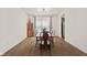 Well lit dining room with hardwood floors, long table and chairs and a hutch at 1026 Sorrell Pass, Greenwood, IN 46143