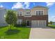 Inviting two-story home with brick and siding, lush lawn, and attached two-car garage at 1026 Sorrell Pass, Greenwood, IN 46143