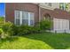 Well-manicured front yard featuring lush landscaping, brick accents, and a two-car garage at 1026 Sorrell Pass, Greenwood, IN 46143