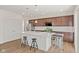 Modern kitchen with stainless steel appliances, dark cabinets, and a white countertop island at 1026 Sorrell Pass, Greenwood, IN 46143