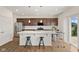 Modern kitchen with stainless steel appliances, dark cabinets, and a white countertop island at 1026 Sorrell Pass, Greenwood, IN 46143