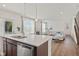 Open concept kitchen view with white countertop island, leading into a living room at 1026 Sorrell Pass, Greenwood, IN 46143