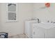 Bright laundry room with a window, featuring a full-size washer and dryer, plus a wire shelf at 1026 Sorrell Pass, Greenwood, IN 46143