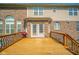 Wooden deck with dark railings offers a spacious outdoor living area, complemented by a brick and siding exterior at 10555 Serra Vista Pt, Fishers, IN 46040