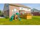 Spacious backyard featuring a wooden deck, a play set with slides, and lush green grass at 10555 Serra Vista Pt, Fishers, IN 46040