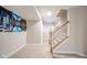 Hallway featuring carpeted floors, painted walls, and wooden stairs, providing a warm and inviting space at 10555 Serra Vista Pt, Fishers, IN 46040