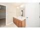 Bathroom featuring a double sink vanity with wooden cabinets, tile floors, and a neutral color scheme at 10555 Serra Vista Pt, Fishers, IN 46040