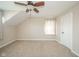 Carpeted bedroom boasts a ceiling fan, dormer window, and convenient closet access at 10555 Serra Vista Pt, Fishers, IN 46040