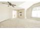 Bright, carpeted bedroom with vaulted ceiling, fan, and a doorway to an ensuite bathroom at 10555 Serra Vista Pt, Fishers, IN 46040