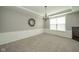 Spacious dining room with wainscoting, a chandelier, and carpet flooring at 10555 Serra Vista Pt, Fishers, IN 46040