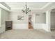 Dining room with wainscoting, chandelier, and view into the kitchen at 10555 Serra Vista Pt, Fishers, IN 46040
