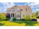 Charming two-story home with a combination of stone and siding and a well-manicured lawn at 10555 Serra Vista Pt, Fishers, IN 46040