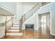 Open foyer with hardwood floors and a staircase with ornamental iron at 10555 Serra Vista Pt, Fishers, IN 46040