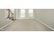 Living room adjacent to staircase with neutral walls and carpet at 10555 Serra Vista Pt, Fishers, IN 46040
