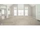 Bright living room with high ceilings, large windows, and neutral carpet at 10555 Serra Vista Pt, Fishers, IN 46040