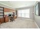 Spacious office featuring built-in shelving, desk, and a large window for natural light at 10555 Serra Vista Pt, Fishers, IN 46040