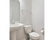 Clean and simple bathroom with a pedestal sink, toilet, and minimalist decor at 11509 Reagan Dr, Fishers, IN 46038