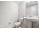 Bathroom featuring a pedestal sink and toilet with tile flooring at 11509 Reagan Dr, Fishers, IN 46038