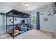 A cozy bedroom featuring a loft bed, a desk and carpeted floors, perfect for or teens at 11509 Reagan Dr, Fishers, IN 46038