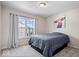 A bright bedroom featuring a bed with a blue comforter and view of the outdoors from the window at 11509 Reagan Dr, Fishers, IN 46038