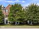 Street view of brick townhomes with mature trees and well-maintained lawns at 11509 Reagan Dr, Fishers, IN 46038