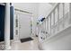 Bright foyer featuring tile flooring, white staircase, and natural light from the front door windows at 11509 Reagan Dr, Fishers, IN 46038