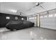 Spacious garage featuring a car covered and epoxy flooring at 11509 Reagan Dr, Fishers, IN 46038