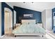 View of a primary bedroom with blue accent wall, carpet and natural lighting from the window at 11509 Reagan Dr, Fishers, IN 46038