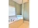 Close-up of a bathroom featuring a standalone tub, tiled walls, and a bright window at 1176 Everton Ct, Greenwood, IN 46143