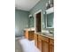 A classic bathroom with double sinks, modern hardware, wooden cabinets, and stylish mirrors at 1176 Everton Ct, Greenwood, IN 46143