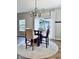 Bright dining area featuring a round table, stylish light fixture, and large windows at 1176 Everton Ct, Greenwood, IN 46143