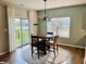 Bright dining area with a stylish chandelier, access to the patio, and lots of natural light at 1176 Everton Ct, Greenwood, IN 46143