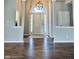 Grand foyer with gleaming hardwood floors, soaring ceilings, and decorative lighting at 1176 Everton Ct, Greenwood, IN 46143