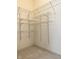 A spacious walk-in closet features carpet and built-in shelving for organization at 1176 Everton Ct, Greenwood, IN 46143